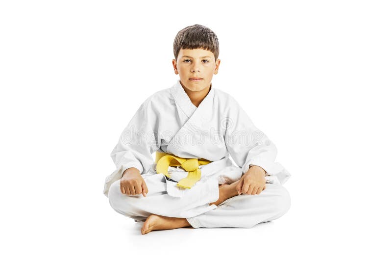 Little karate kid sitting legs crossed royalty free stock photography Little karate kid sitting legs crossed royalty free stock photography