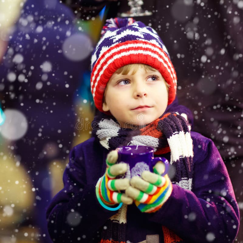 Little kid boy with hot chocolate on Christmas market royalty free stock image Little kid boy with hot chocolate on Christmas market royalty free stock image