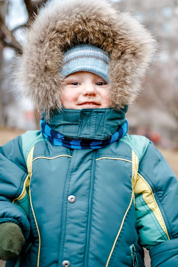 The Little Kid in the Jacket with Fluffy Fur Outdoors Stock Image ...