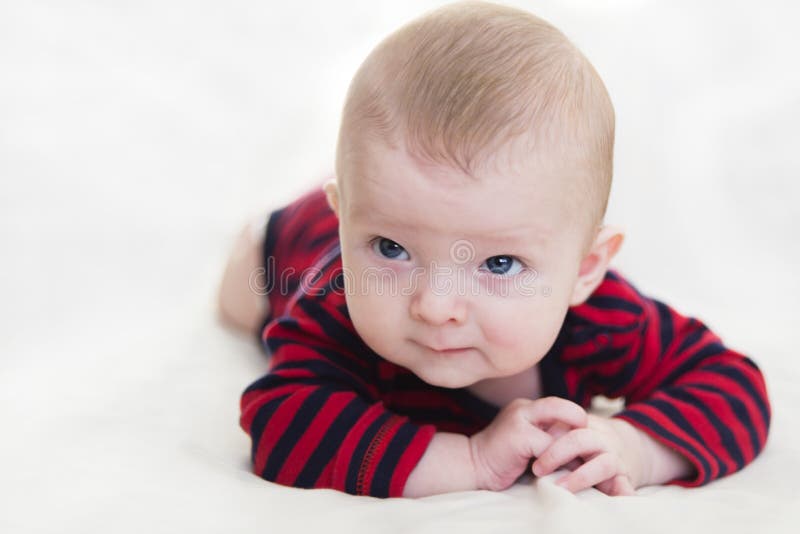 Little Kid Lying Down On White Bed Pretty Baby Is Lying On The White