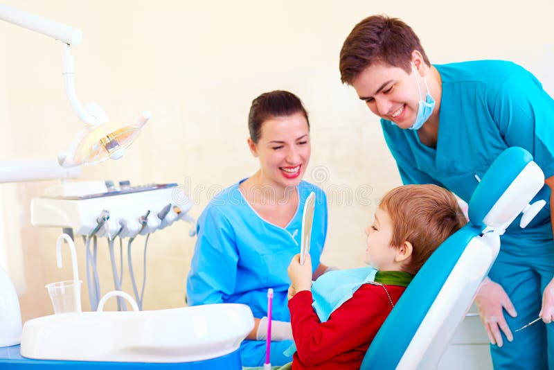 Little kid, patient checking out the result of medical procedure in dental clinic