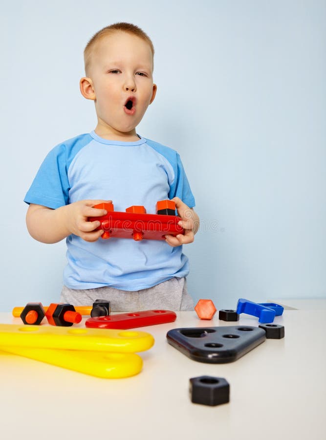 Little Boy Playing with Color Toys on Floor Stock Photo - Image of  bulldozer, little: 19039326