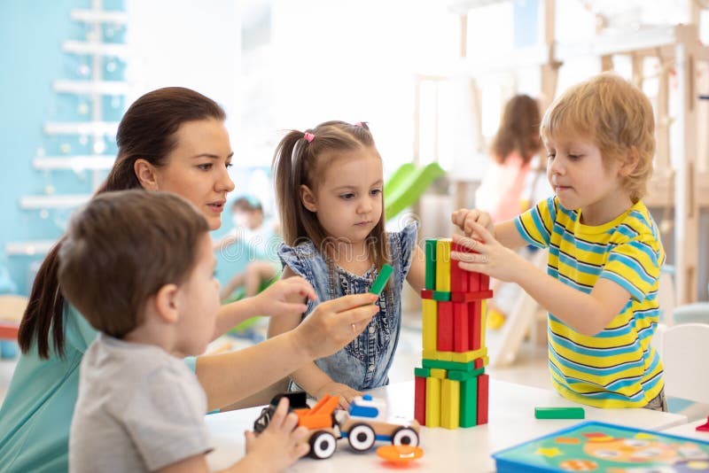 Little kids build block toys at home or daycare. Kids playing with color blocks. Educational toys for preschool and kindergarten