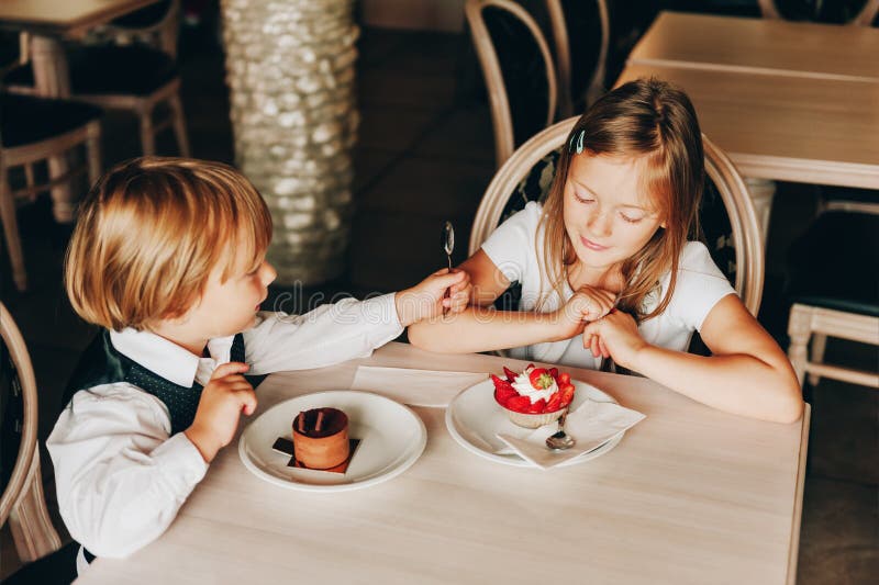 Little kids enjoying delicious desserts royalty free stock photography Little kids enjoying delicious desserts royalty free stock photography