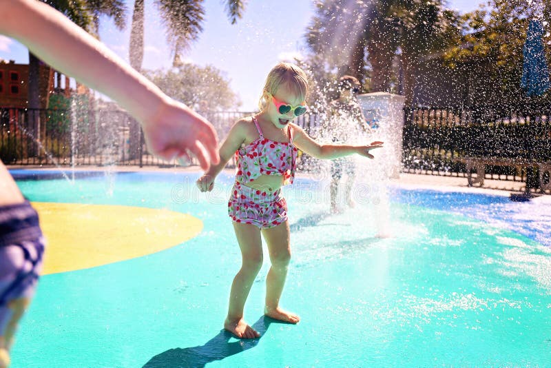 Little Kids Playing Outside in Water Fountains at Outdoor Splash Park stock images Little Kids Playing Outside in Water Fountains at Outdoor Splash Park stock images