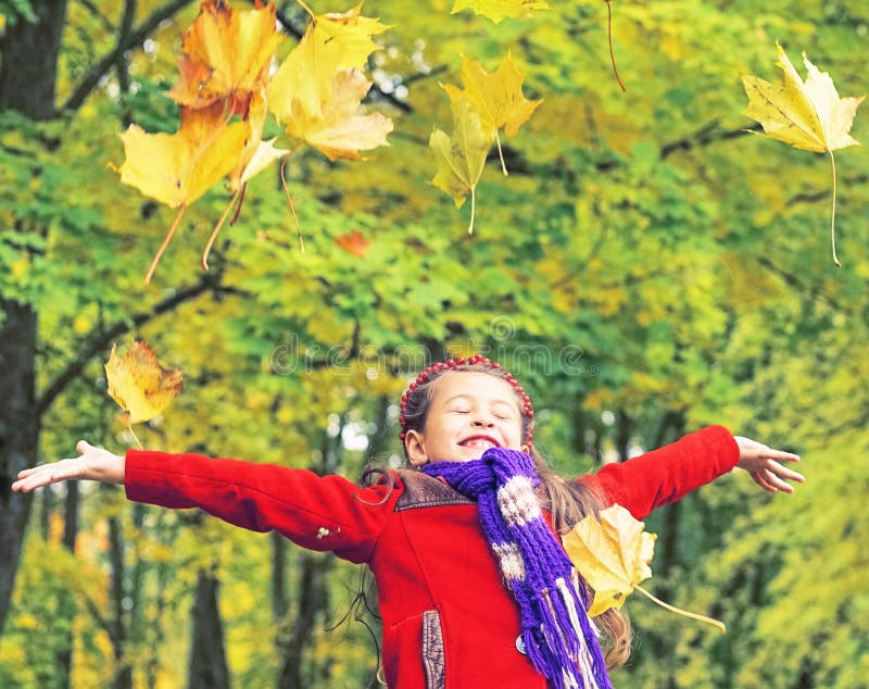Little laughing pretty girl in red coat throws yellow leaves in autumn park royalty free stock image Little laughing pretty girl in red coat throws yellow leaves in autumn park royalty free stock image