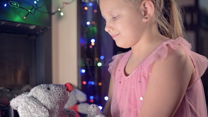 Little Lonely Cheerful Fat Girl Playing with a Soft Toy Rat on the Background of an Electric Fireplace and Blinking New Stock Video - Video of small, adorable: 204530911