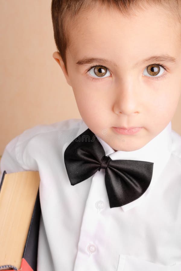Little nerd boy in bow tie stock image. Image of book 17859365