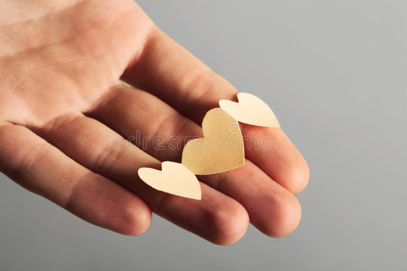 Little paper cutout hearts on hand stock photos