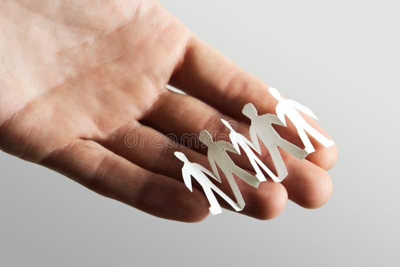 Little paper cutout people on hand royalty free stock photos