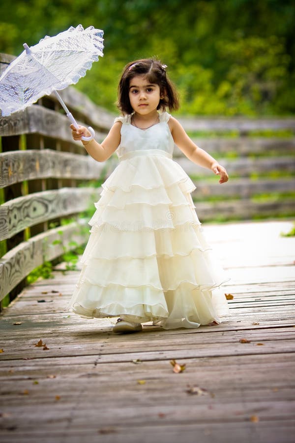 A toddler's walk in the fall holding a parasol and wearing a princess dress. Hdr bridge stock images, royalty-free photos and pictures