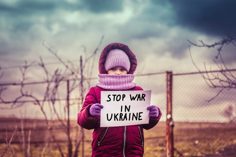 Little refugee girl with a sad look and a poster that says stop war in Ukraine. Social problem of refugees and internally displace