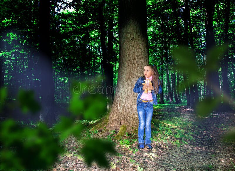 Little scared girl in the forest