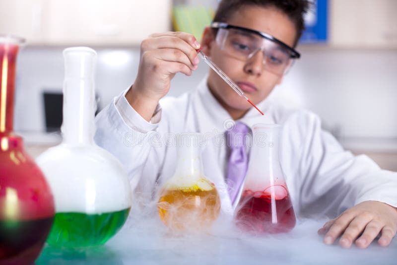 Young scientist boy working in a laboratory. Young scientist boy working in a laboratory