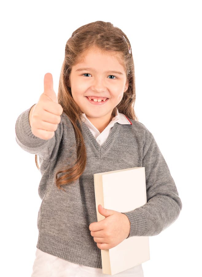 Little schoolgirl holding a book giving a thumbs-up royalty free stock image Little schoolgirl holding a book giving a thumbs-up royalty free stock image