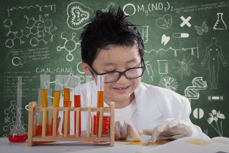 Photo of a little scientist using chemical liquid to create experiments in the laboratory. Photo of a little scientist using chemical liquid to create experiments in the laboratory