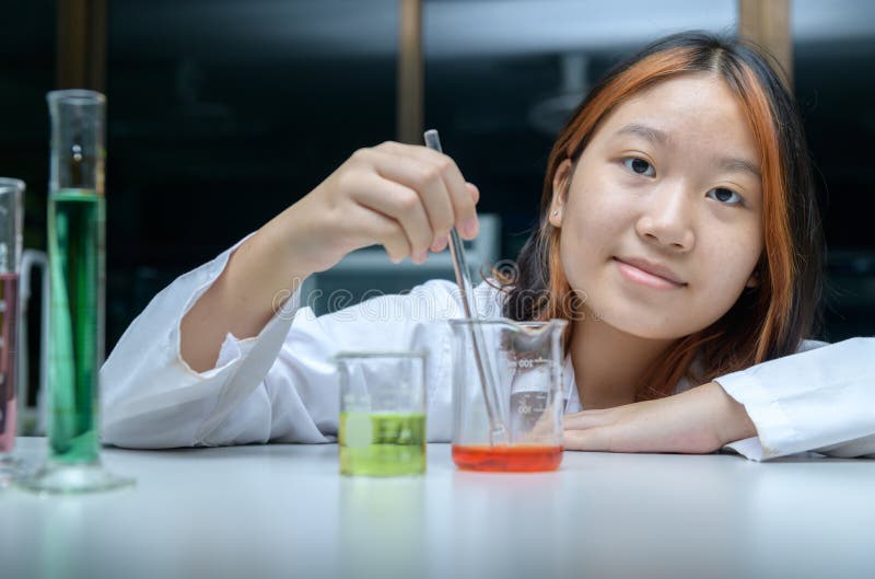 Little scientists manned chemicals in beakers. science and education stock image