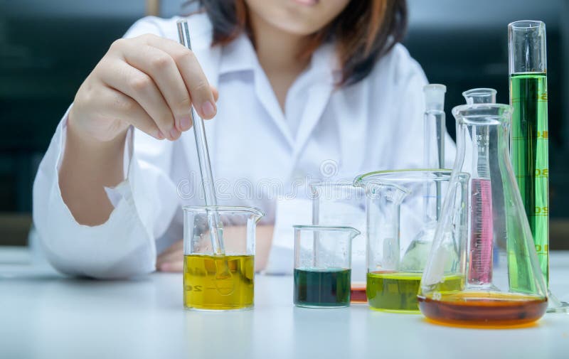 Little scientists manned chemicals in beakers. science and education royalty free stock image