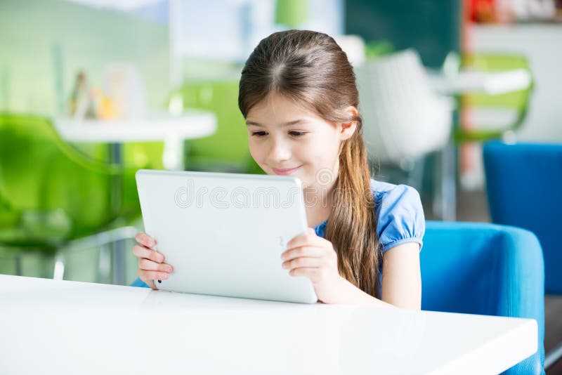 Little smiling girl with Apple iPad Air royalty free stock image