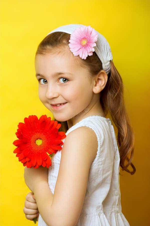 Little smiling girl with flowers