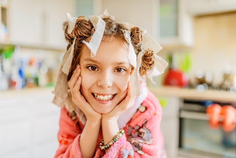 Little smiling girl with hair curlers on her head royalty free stock images Little smiling girl with hair curlers on her head royalty free stock images