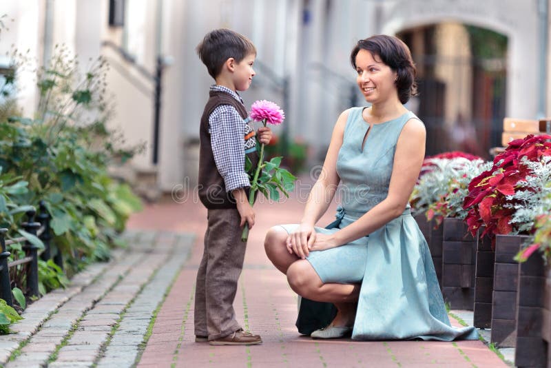 Little Son Giving a Flower To Mother Stock Image Image of outdoors