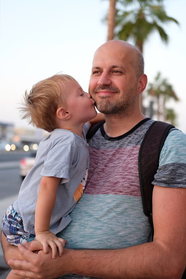 The little son is kissing his father on a cheek royalty free stock photo The little son is kissing his father on a cheek royalty free stock photo