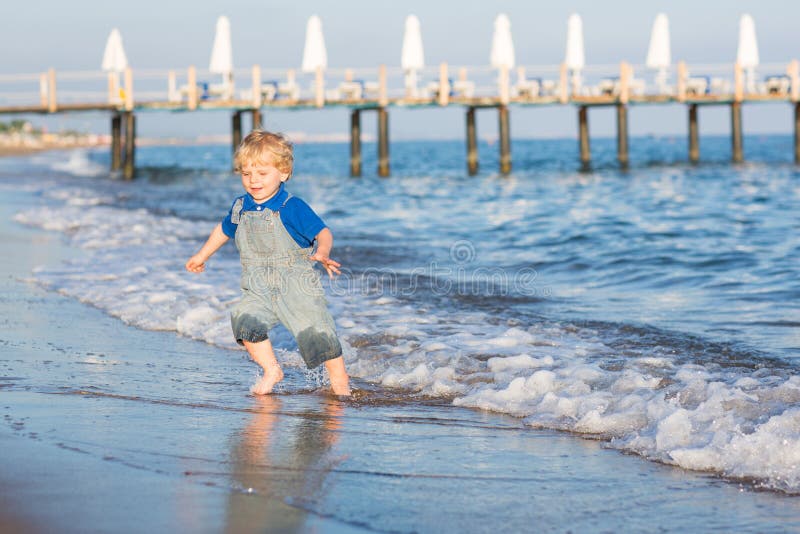 Little Toddler Boy Having Fun on the Beach in Summer Stock Image