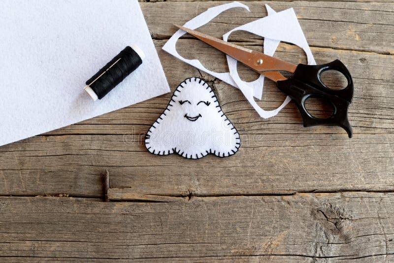 Cute white ghosts crafts, felt sheets, scissors, thread, needles
