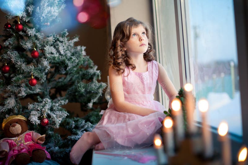Littlle Girl Dreaming Near Christmas Tree Stock Photo Image of events