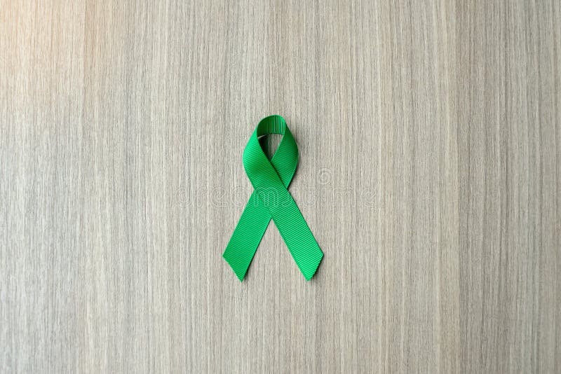 Top View Of Emerald Green Ribbon On Dark Wood Background Liver Cancer  Awareness Concept High-Res Stock Photo - Getty Images