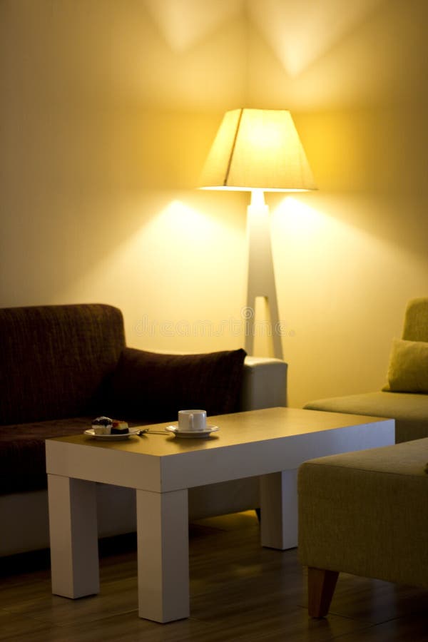 Living Room with the Cake on the Table and Big Yellow Lamp in the