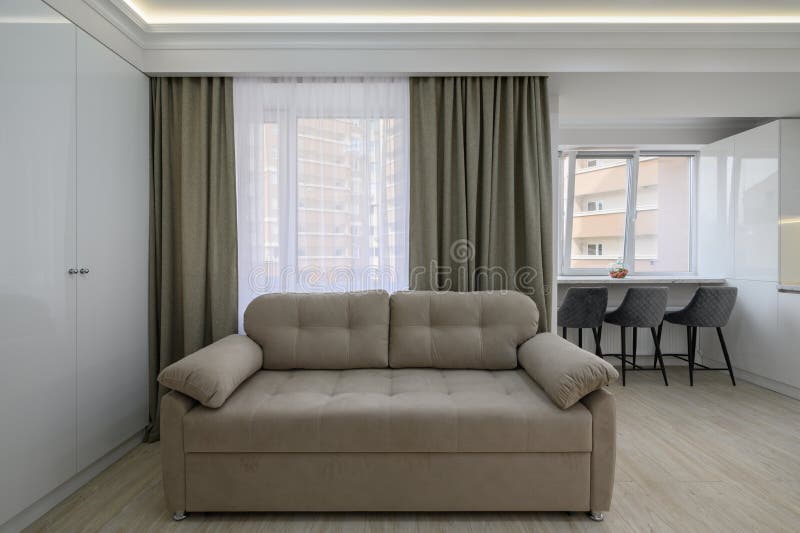 Living Room with a Couch and a Kitchen in the Background Stock Image