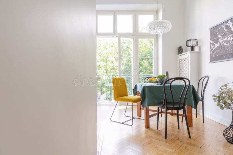 Living room interior with table cloth and different kind of chairs, black map on the wall, real photo with royalty free stock image Living room interior with table cloth and different kind of chairs, black map on the wall, real photo with royalty free stock image