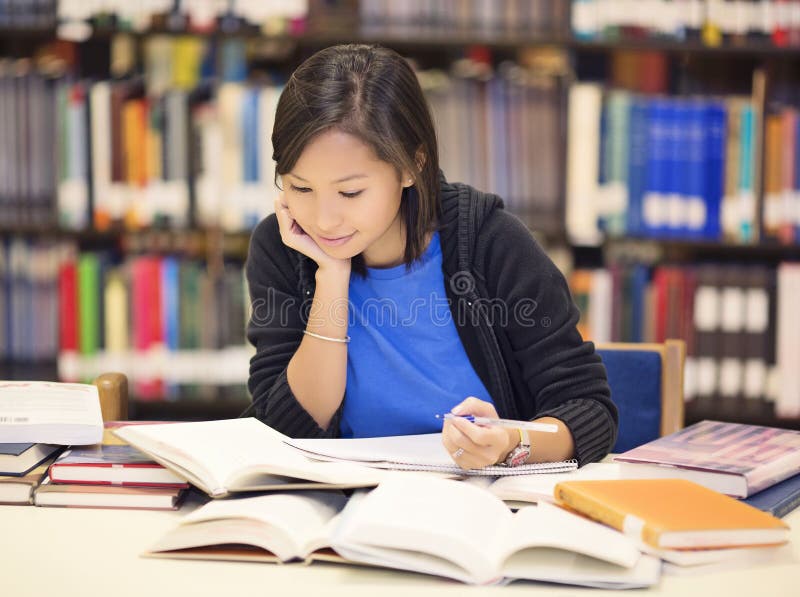 Asina student sitting and reading book in library. Asina student sitting and reading book in library