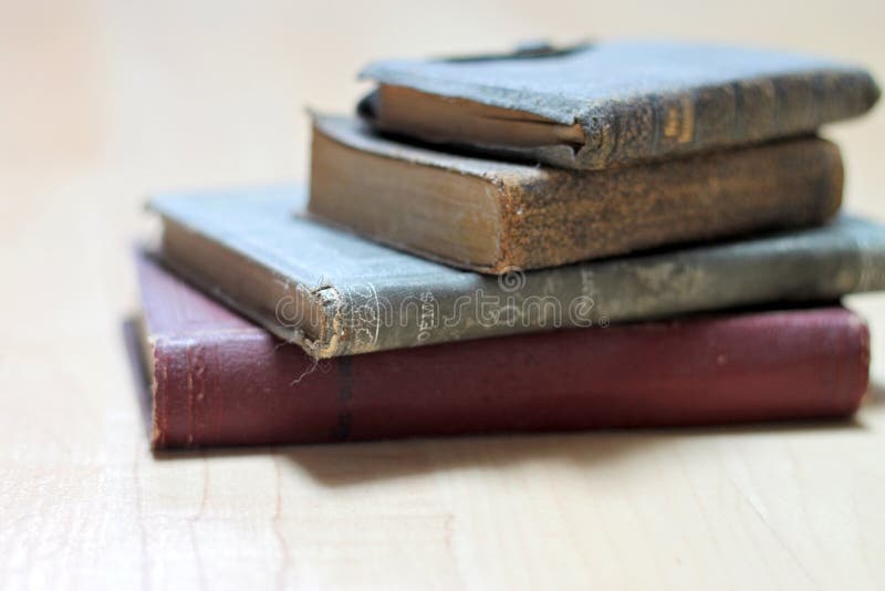 Stack of dusty worn books on poetry and and a bible. Stack of dusty worn books on poetry and and a bible