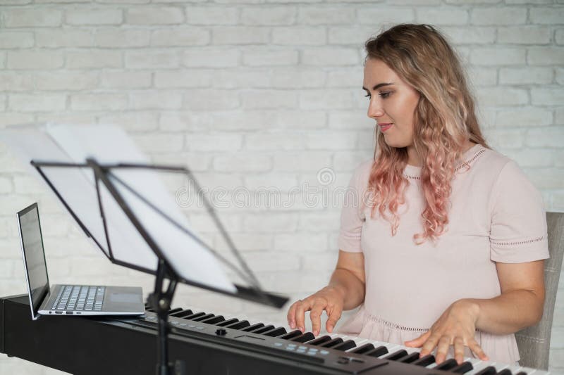 Remote music lessons. A singing teacher records the lesson on a laptop webcam. Remote music lessons. A singing teacher records the lesson on a laptop webcam