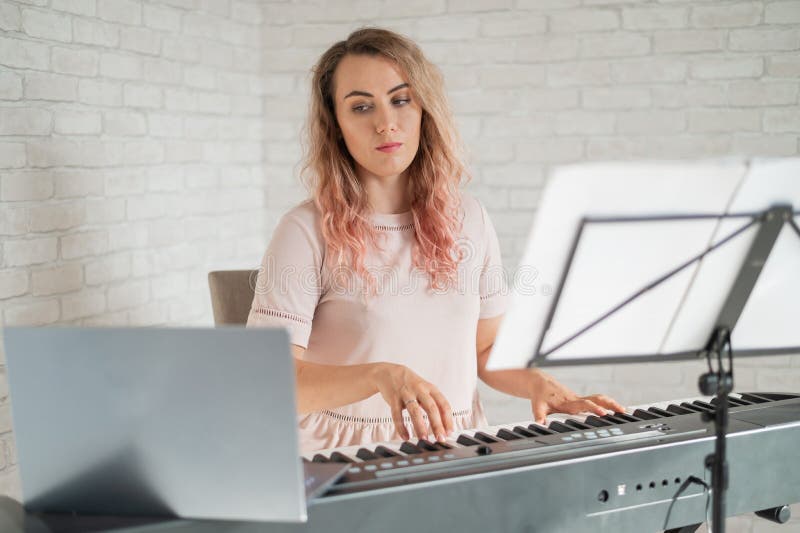 Remote music lessons. A singing teacher records the lesson on a laptop webcam. Remote music lessons. A singing teacher records the lesson on a laptop webcam