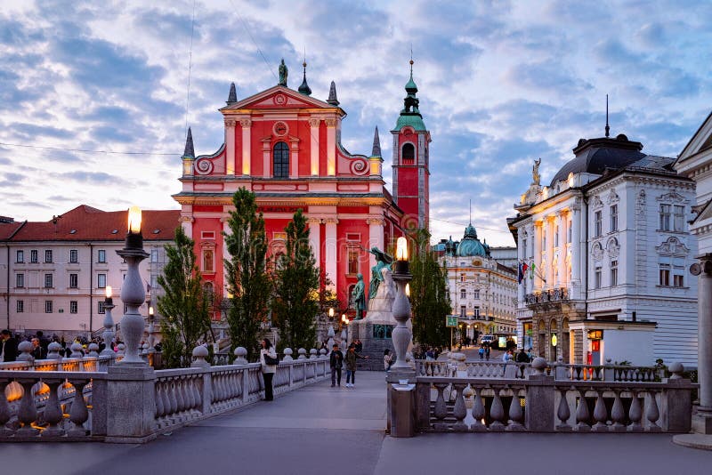 Ljubljana, Slovenia - April 27, 2018: People at Franciscan Church of the Annunciation and Triple Bridge in the historical center