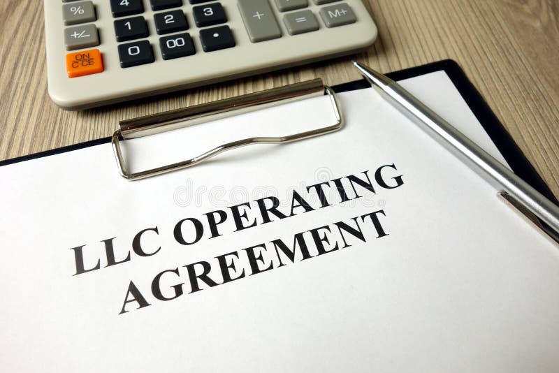 LLC operating agreement, pen and calculator on desk stock images