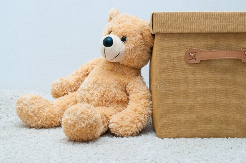 Bear toy and brown textile box with handles and cover on the white background. Bear toy and brown textile box with handles and cover on the white background