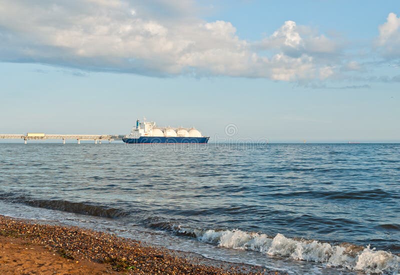 LNG carrier getting liquefied natural gas at specialized berth of the seaport Prigorodnoe,Russia. LNG carrier getting liquefied natural gas at specialized berth of the seaport Prigorodnoe,Russia