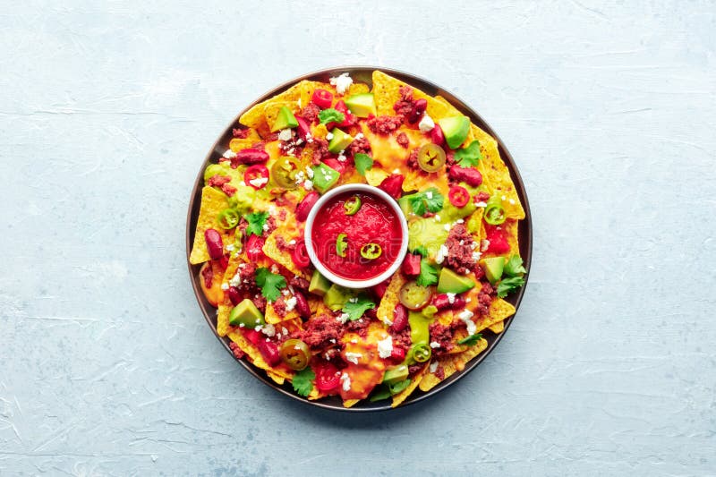 Loaded Nachos. Mexican Nacho Chips with Beef and Guacamole Sauce Stock
