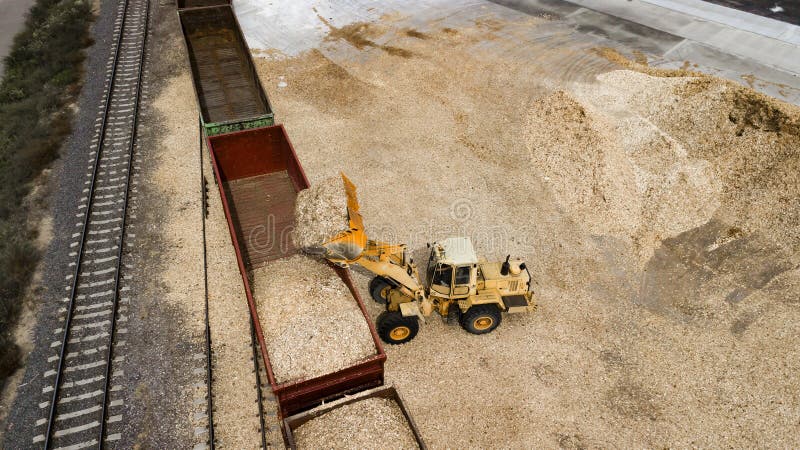 The loader loads the sawdust in the woodworking factory aerial view
