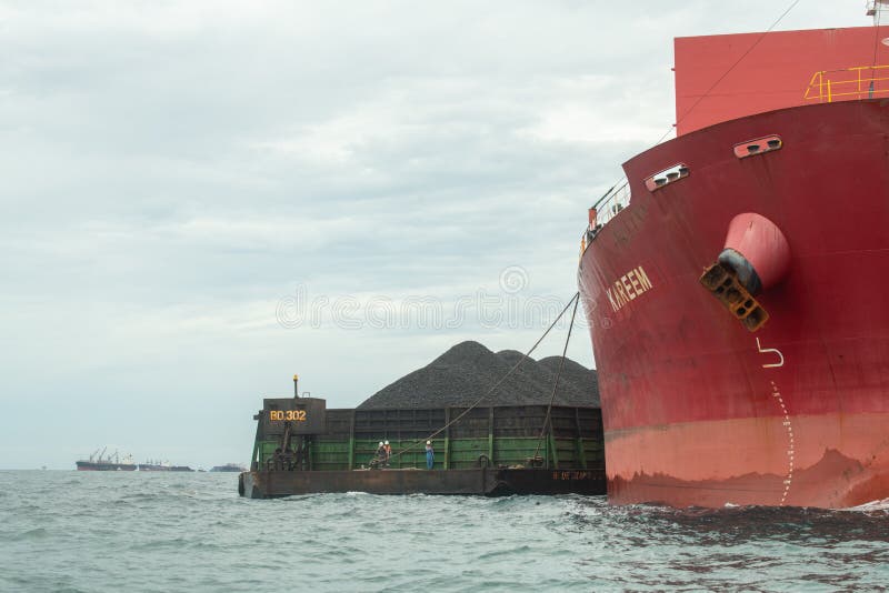 Loading Coal from Cargo Barges Onto a Bulk Vessel Using Ship Cranes