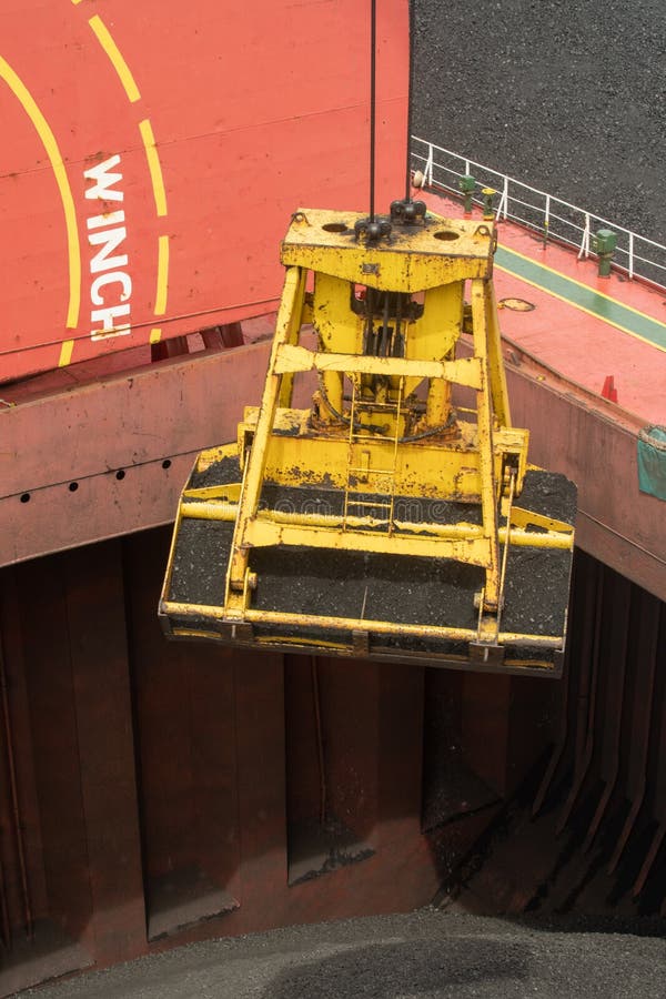 Loading Coal from Cargo Barges Onto a Bulk Vessel Using Ship Cranes in