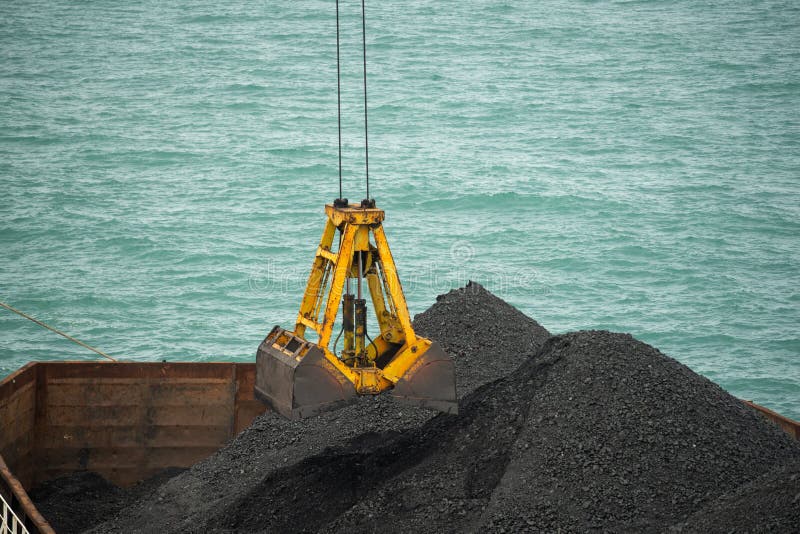 Loading Coal from Cargo Barges Onto a Bulk Vessel Using Ship Cranes in