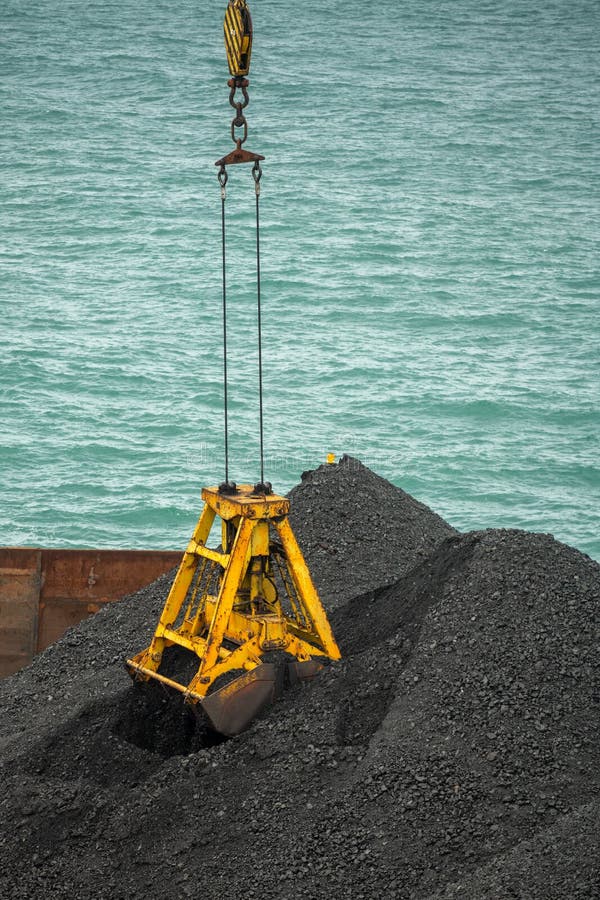 Loading Coal from Cargo Barges Onto a Bulk Vessel Using Ship Cranes in