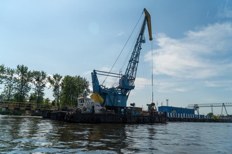 Loading and Unloading Crane Mounted on a Small Barge Stock Photo
