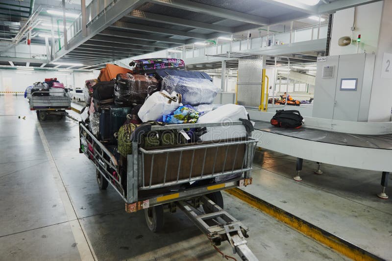 Loading and unloading operations and baggage control at the airport. Service for the transportation of belongings of aircraft stock photo